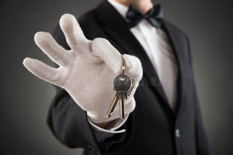 Close-up Of Waiter Holding Keys