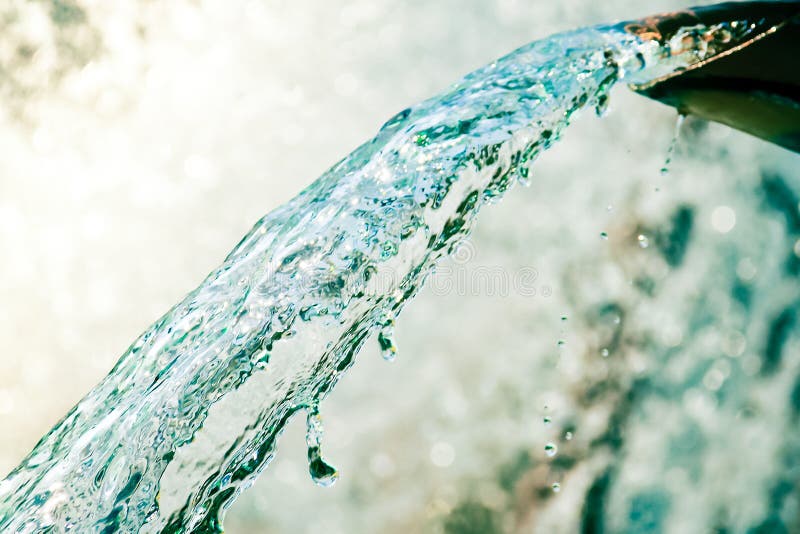 Close up of water gushing out of the pipe stock images