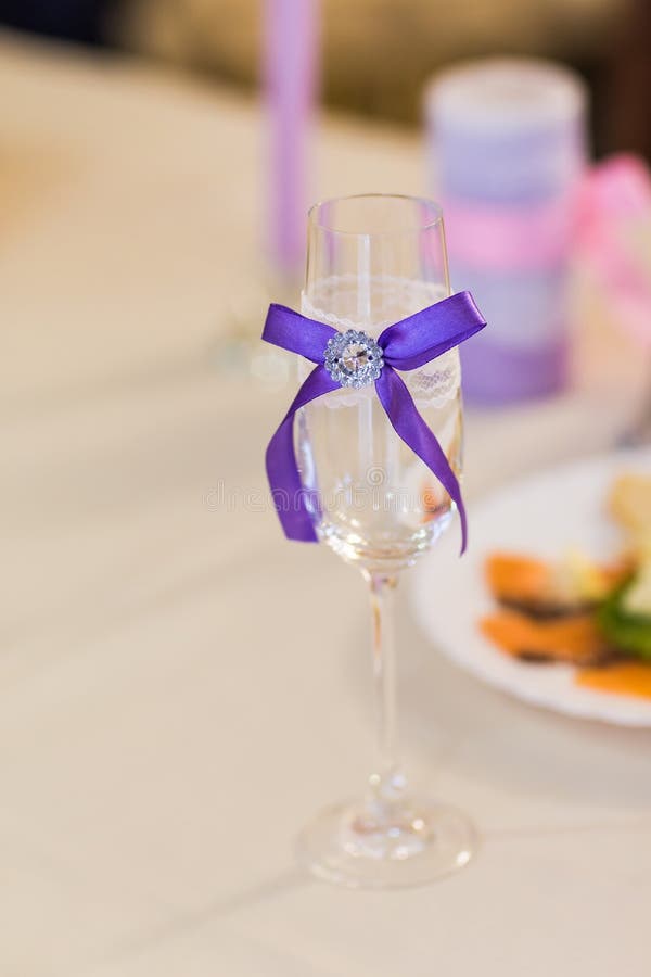 Closeup of Wedding Decorated Champagne Glass on the Table Stock Photo