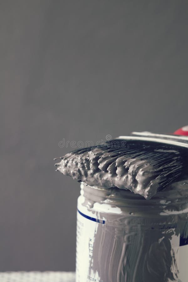 Close Up of Wet Paint on Brush on Sample Pot Vertical Stock Photo