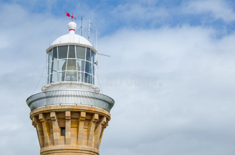 Close-up the white lighthouse tower in cloudy sky day at Barrenjoey headland, Sydney, Australia.