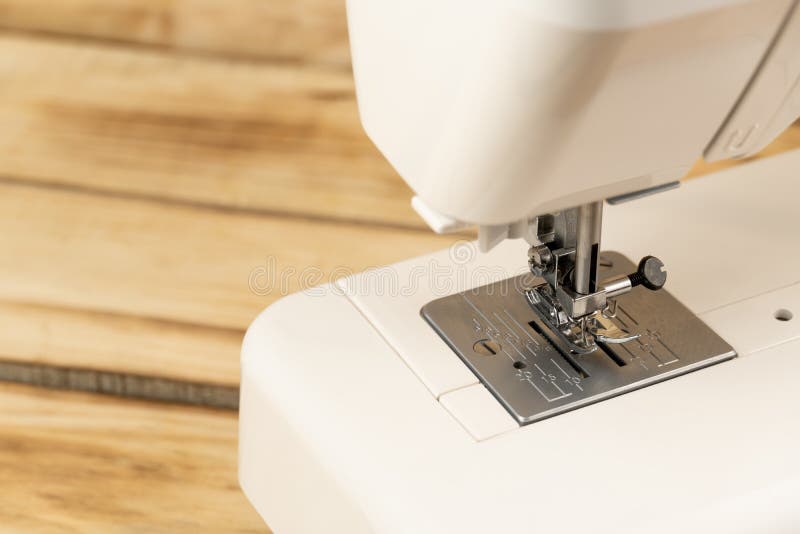 Closeup of a White Sewing Machine and Sewing Machine Feet . Sewing and