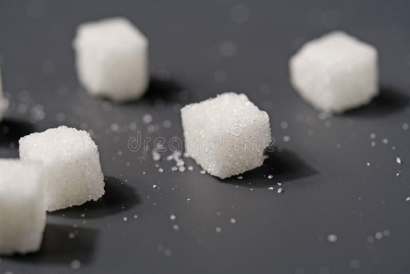 White sugar cubes on black table stock photography White sugar cubes on black table stock photography