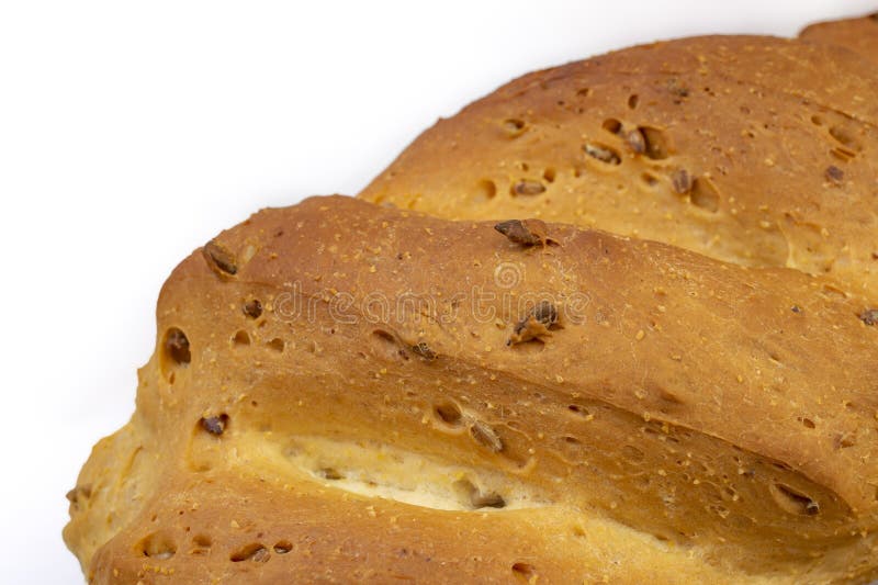 Close up of a white wheat bread crust with sunflower seeds on white background royalty free stock photography