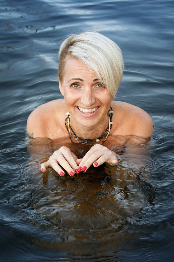 Close-up of a Woman Blonde Middle-aged Nude Swims in the River, Selective  Focus Stock Photo - Image of naturalness, female: 157146824