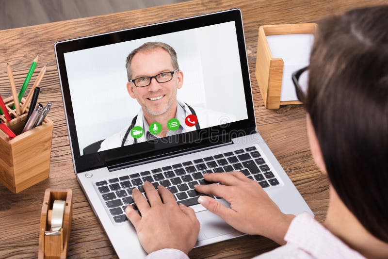 Woman Doing Video Chatting With A Male Doctor royalty free stock photo Woman Doing Video Chatting With A Male Doctor royalty free stock photo