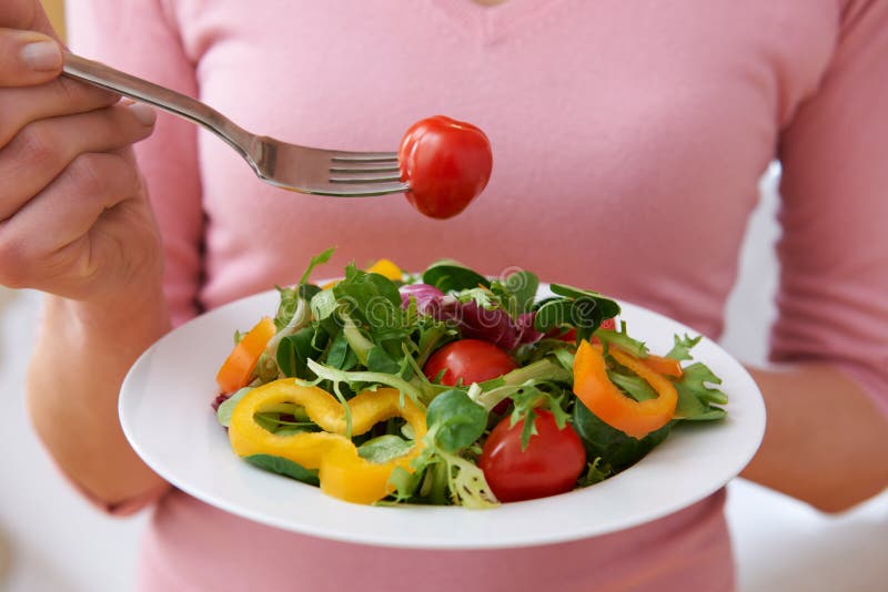 Close Up Of Woman Eating Healthy Salad