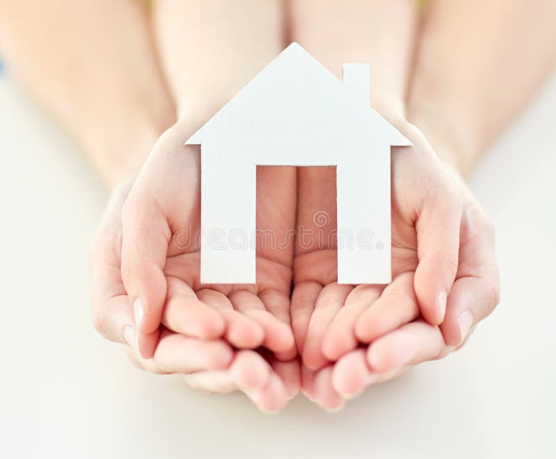 Close up of woman and girl hands with paper house