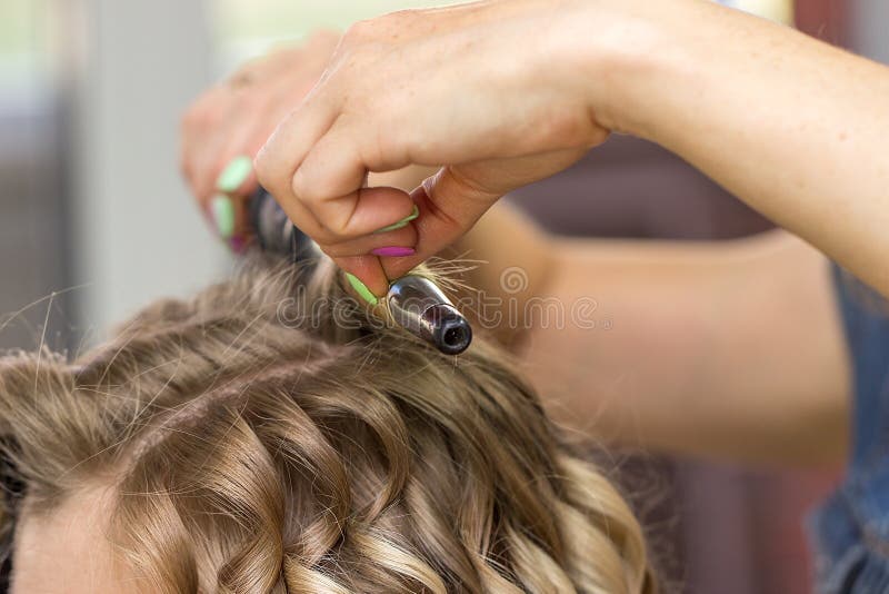 Close-up of a woman hairdresser making curls stock photos Close-up of a woman hairdresser making curls stock photos