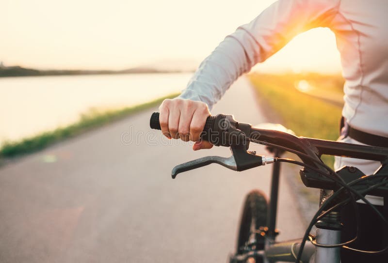 Close up woman hand on the bicycle handlebars