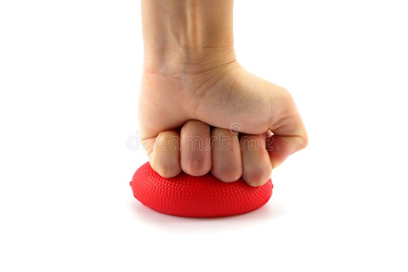 Close up woman hand squeezing a stress ball isolated on white background. Close up woman hand squeezing a stress ball isolated on white background