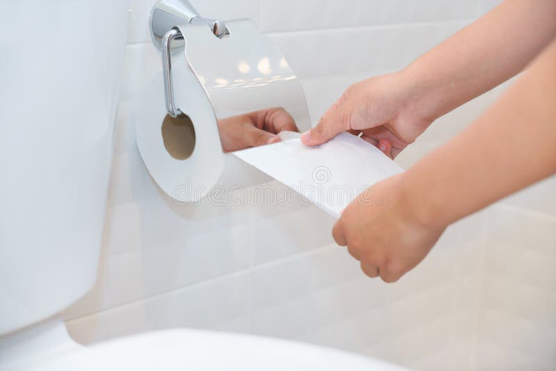 Close up of A woman hand using toilet paper in white and clean t stock images Close up of A woman hand using toilet paper in white and clean t stock images
