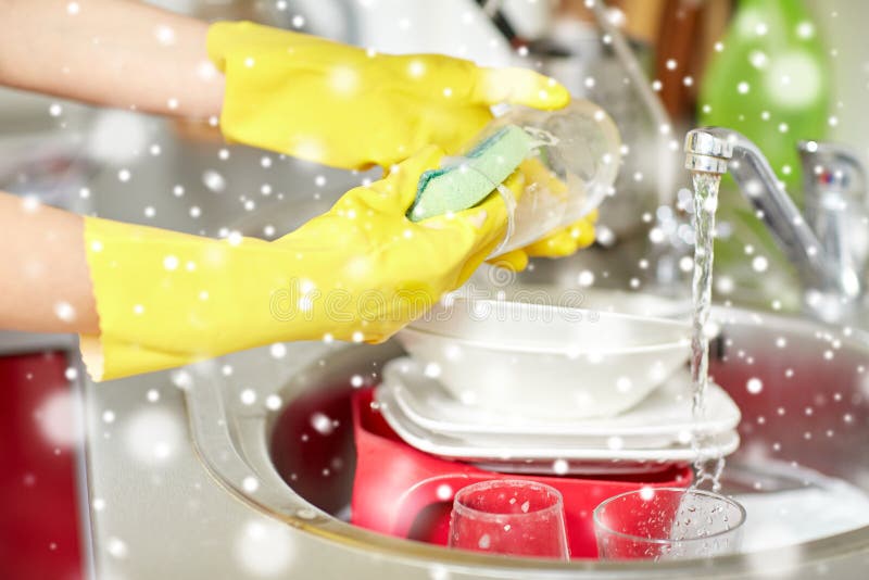 Close up of woman hands washing dishes in kitchen