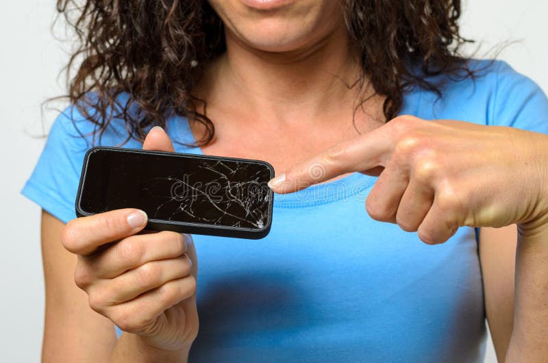 Close up of woman holding broken mobile phone stock photo Close up of woman holding broken mobile phone stock photo