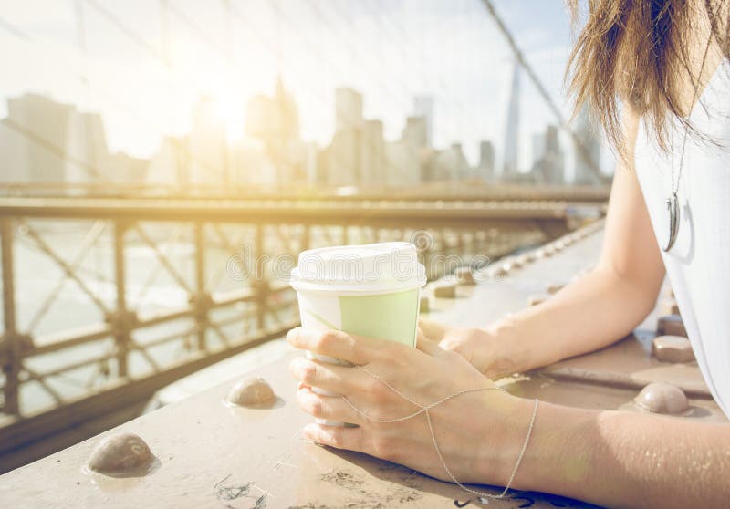 Close up on a woman holding coffee paper cup