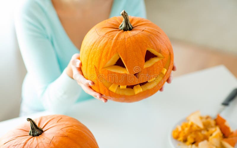 Close up of woman with pumpkins at home