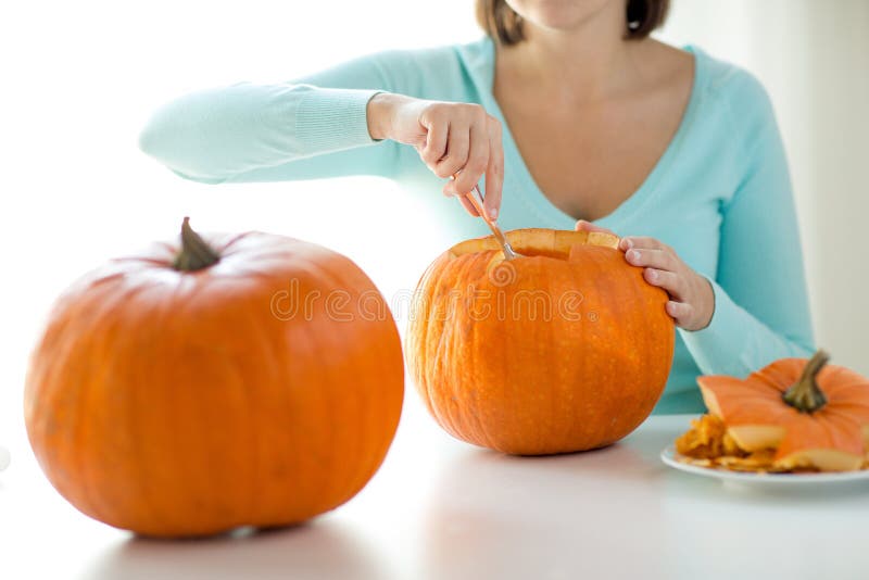 Close up of woman with pumpkins at home