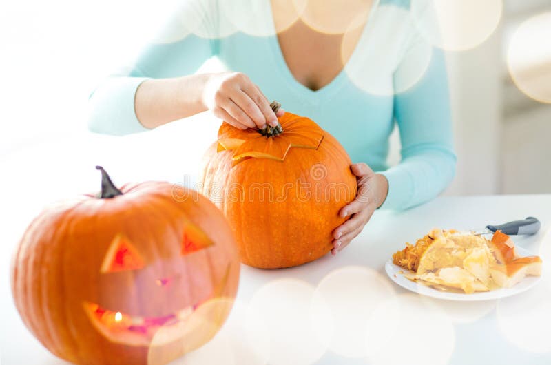 Close up of woman with pumpkins at home