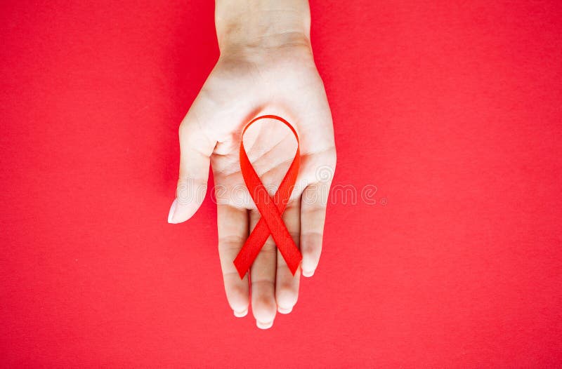 Close Up Of Woman`s Hands Holding Red Ribbon Calling For Safe Sex And