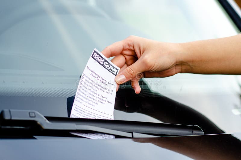 Close-up Of A Woman Taking Parking Ticket On Car`s Windshield stock images Close-up Of A Woman Taking Parking Ticket On Car`s Windshield stock images