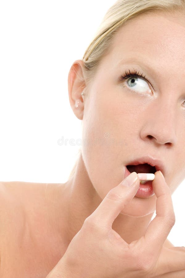 Close up of woman taking pill