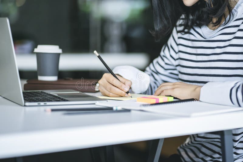 Close Up of Woman Working or Writing Something on the Book in the ...