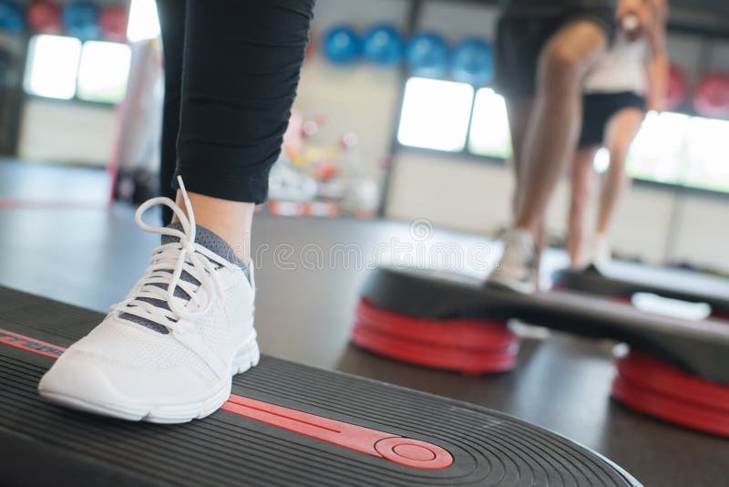 Close up women foot exercising with stepper in gym.