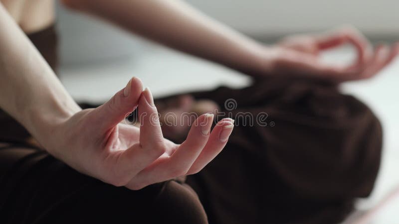 A close-up of women`s hands. Girl practices yoga stock video