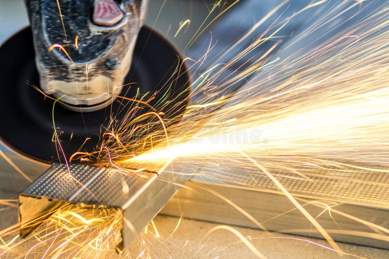 Close-up of worker cutting metal with grinder. Sparks while grin stock images Close-up of worker cutting metal with grinder. Sparks while grin stock images