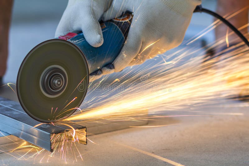Close-up of worker cutting metal with grinder. Sparks while grin royalty free stock image Close-up of worker cutting metal with grinder. Sparks while grin royalty free stock image