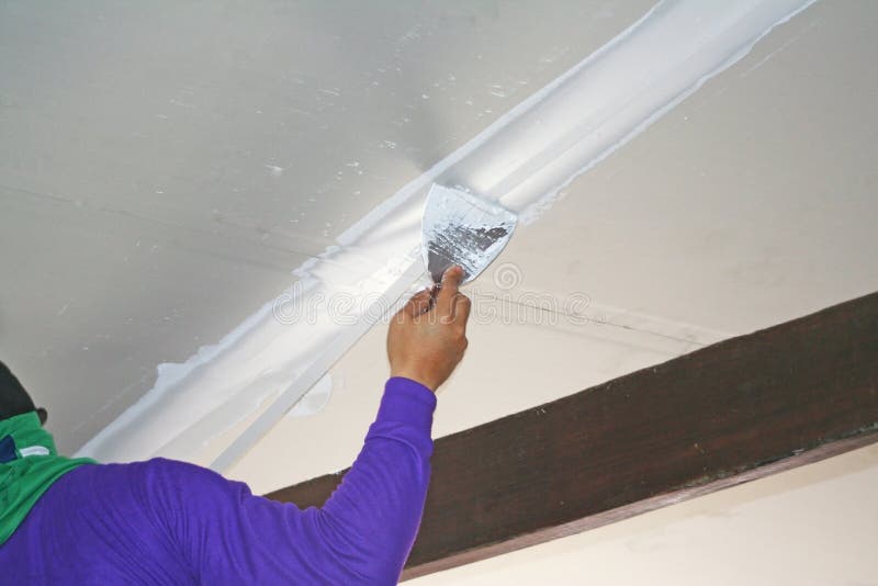 Worker Using Plaster Gypsum On Putty Knife At Ceiling Stock