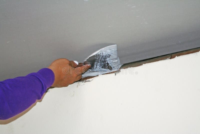 Worker Using Plaster Gypsum On Putty Knife At Ceiling Stock