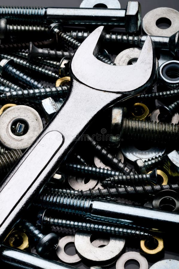 A close-up of a wrench with metal fasteners