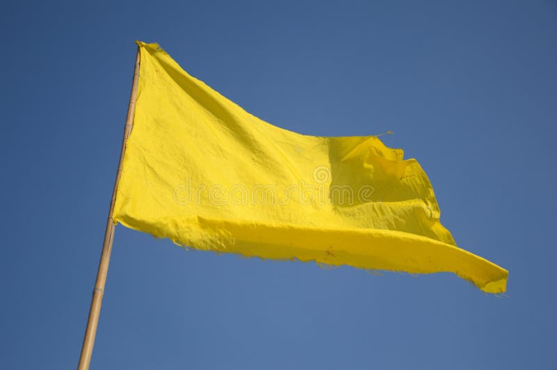 Yellow flag on blue sky stock photo. Image of close - 124235078