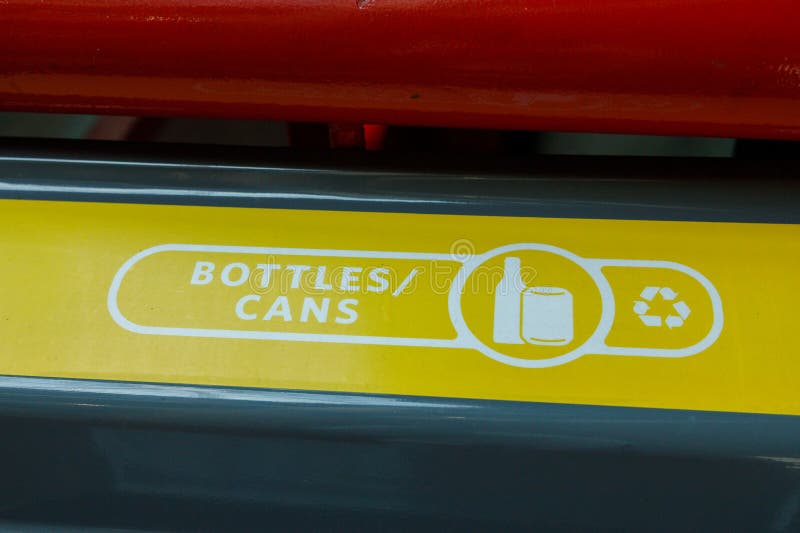 Yellow recycling bin lid labeled BOTTLES,CANS royalty free stock images