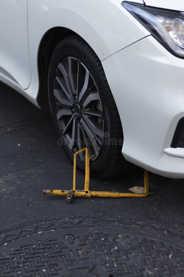 Close Up of Yellow Wheel Locks, White Car Stock Photo Image of park