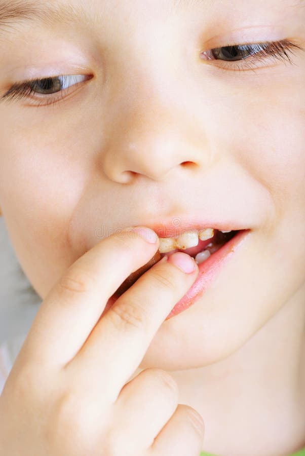 Close Up of Young Boy Eating A chocolate