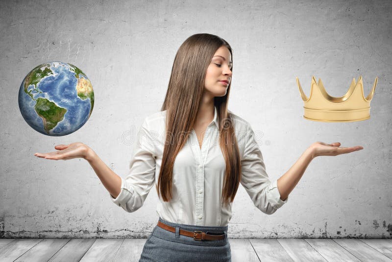 Close-up of young businesswoman, elbows bent, hands at sides facing up, little Earth and gold crown in air above woman`s