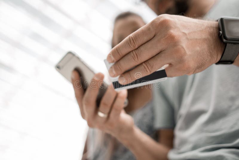 Happy couple shopping online with credit card and smartphone royalty free stock photo Happy couple shopping online with credit card and smartphone royalty free stock photo