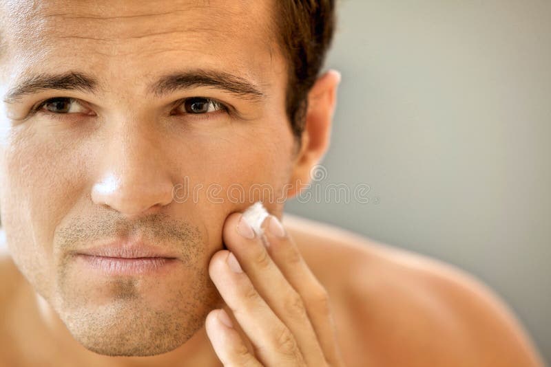 Close-up of young man applying shaving cream