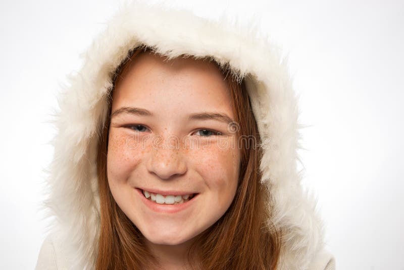 Close-up of young red headed child in a fur coat royalty free stock images