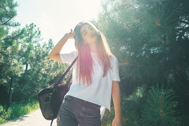 Close-up young woman with beautiful face features enjoying sun