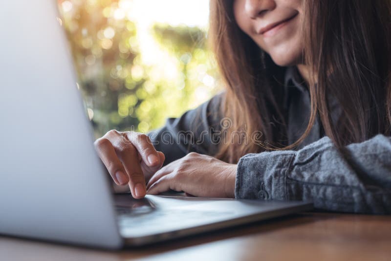 Close-upbeeld van een mooie Aziatische bedrijfsvrouw die, en op laptop toetsenbord werken typen kijken royalty-vrije stock afbeelding Close-upbeeld van een mooie Aziatische bedrijfsvrouw die, en op laptop toetsenbord werken typen kijken royalty-vrije stock afbeelding