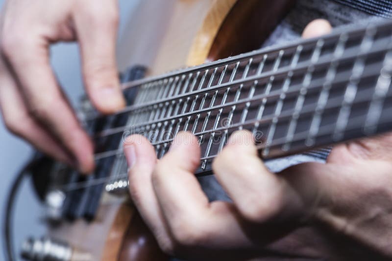 Close-upfoto van de handen van de basgitaarspeler, zachte selectieve nadruk, levend muziekthema stock foto Close-upfoto van de handen van de basgitaarspeler, zachte selectieve nadruk, levend muziekthema stock foto