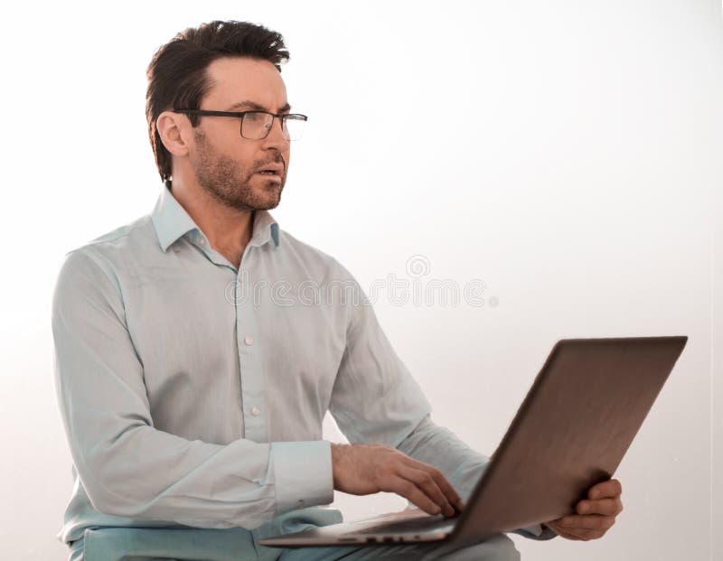 Close up. serious businessman typing text on laptop. photo with copy space