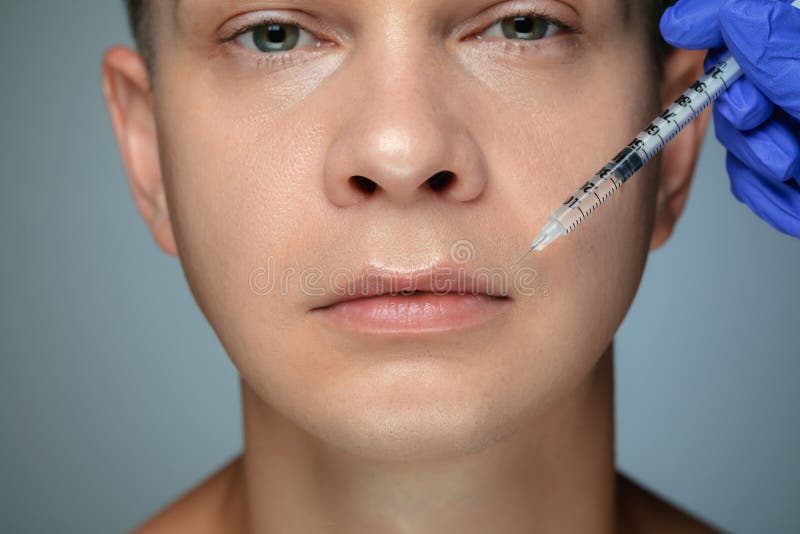 Close-upportret van de jonge mens op grijze studioachtergrond stock fotografie Close-upportret van de jonge mens op grijze studioachtergrond stock fotografie