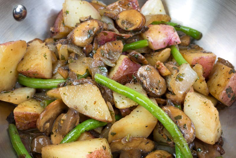 A close view of vegetables cooking in skillet stock photo