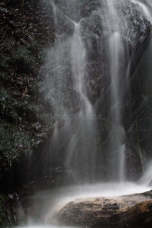 Close Water fall moss rocks stock image