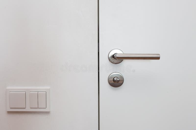 Close white door with metallic handle stock image
