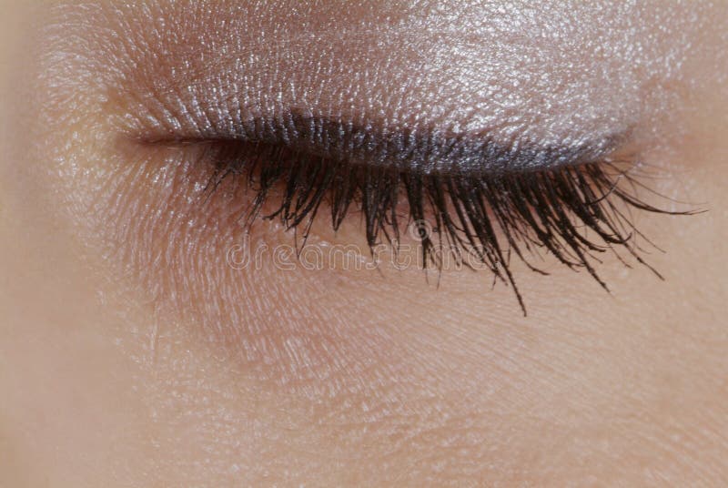 Detail of a closed eye with eyelid shade and mascara